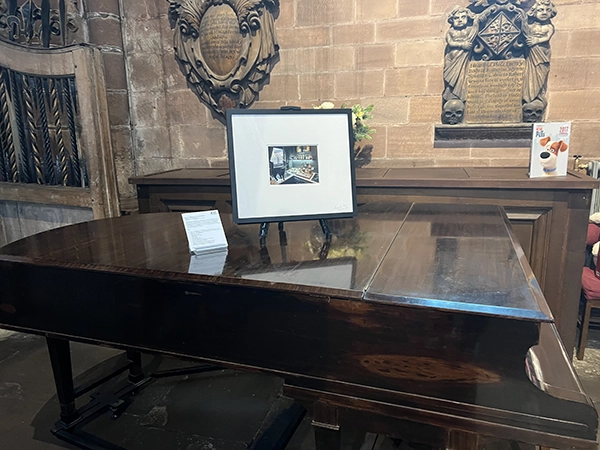 Photography displays integrated within a historic Chester heritage site, St John's Church  during the 2024 Pilot Exhibition.